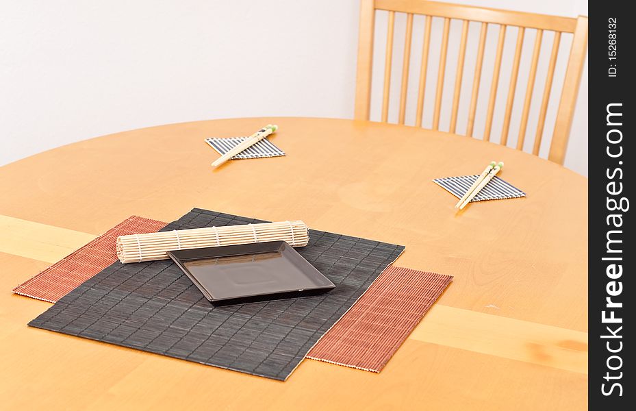 Bamboo Mats with Black Plate on Wood Table. Bamboo Mats with Black Plate on Wood Table