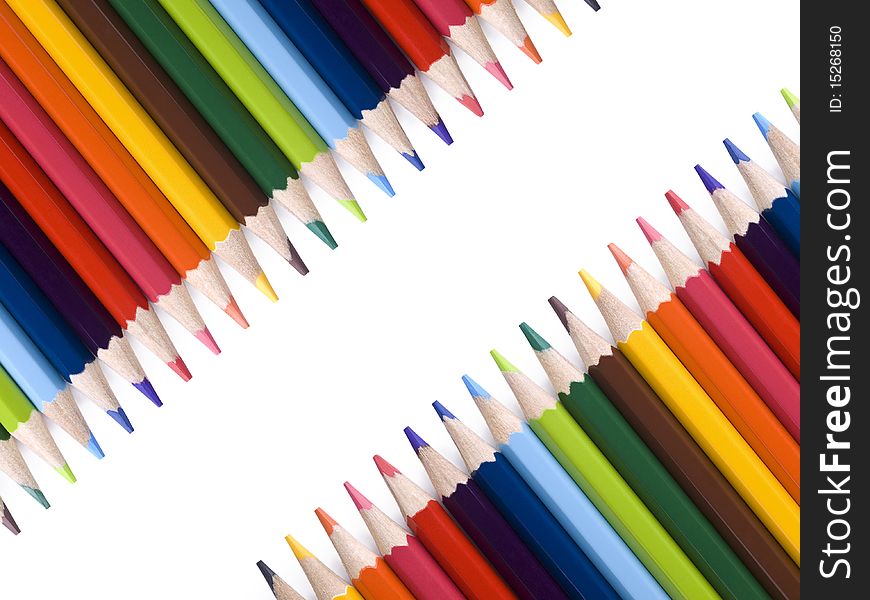 Colored pencils form a frame over a white background. Copy space. Colored pencils form a frame over a white background. Copy space.
