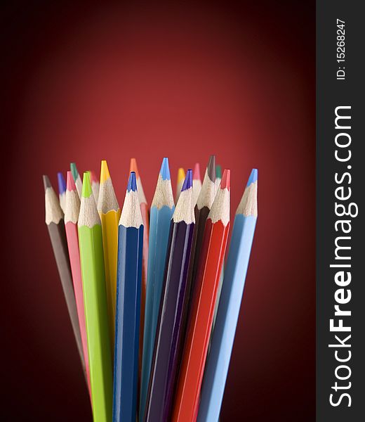 Bunch of pencils over a red background. Copy space. Bunch of pencils over a red background. Copy space.