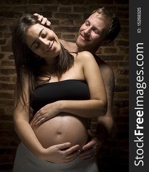 A man caressing his beauty pregnant wife. A man caressing his beauty pregnant wife.