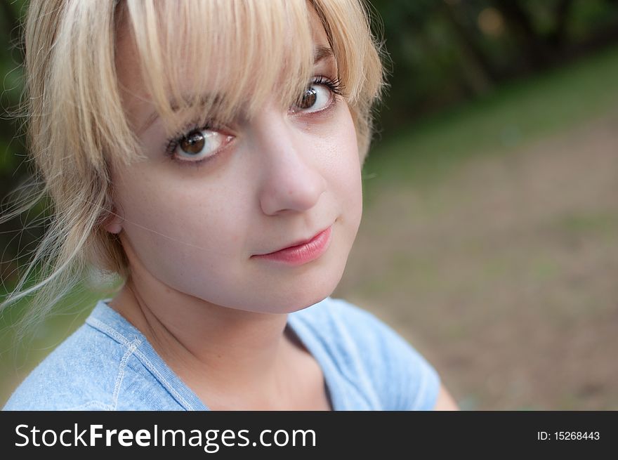 An attractive young female in a park. An attractive young female in a park.