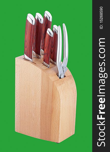 Set of kitchen knifes on green