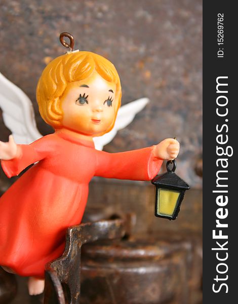 Antique christmas ornament of a little angel holding a lantern