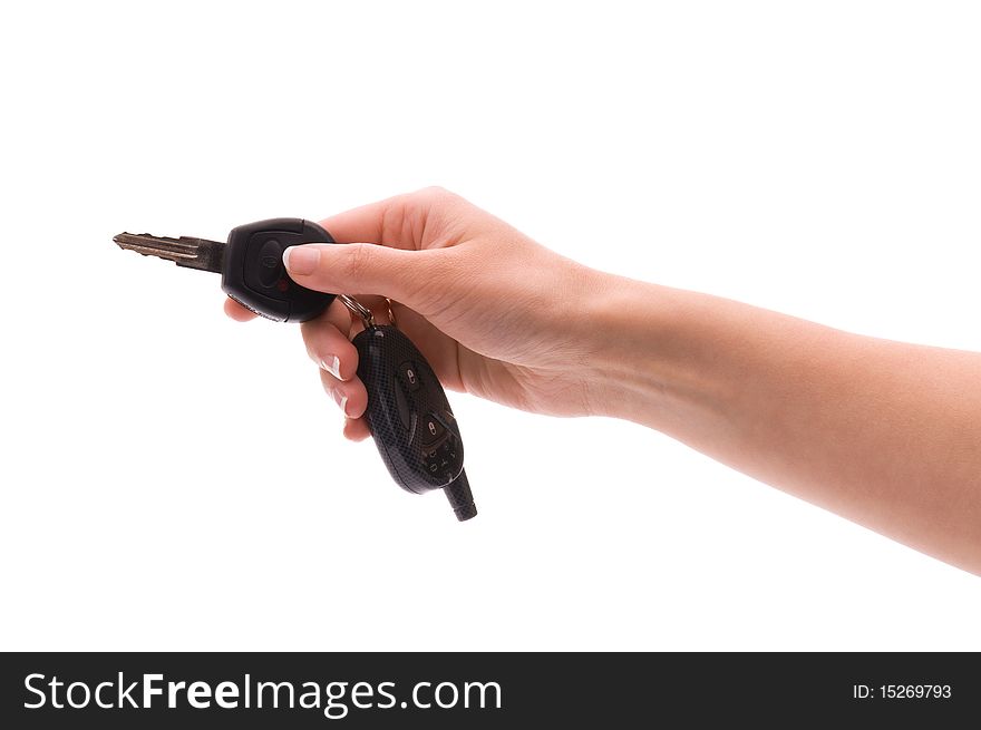 Woman's hand holds out key to the car. Isolated on white background. Woman's hand holds out key to the car. Isolated on white background.