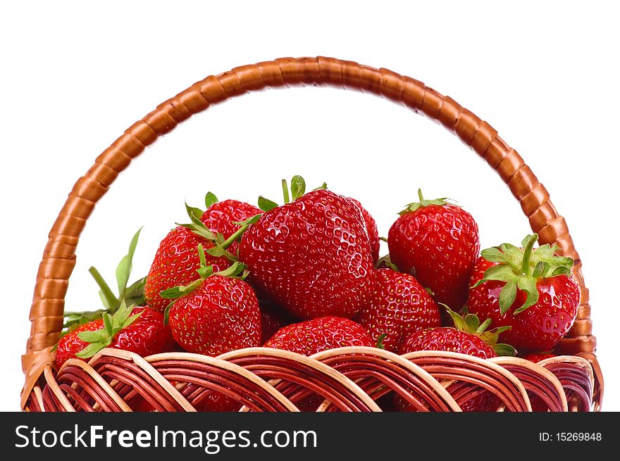 Ripe strawberry in wicker basketbasket isolated on a white background