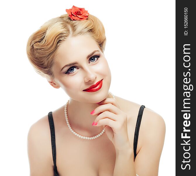 Blonde girl style pin-up in black dress and pearl necklace looks playfully at camera and gently touching face with your