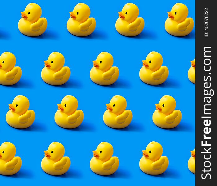 Seamless pattern rubber ducks on a blue background