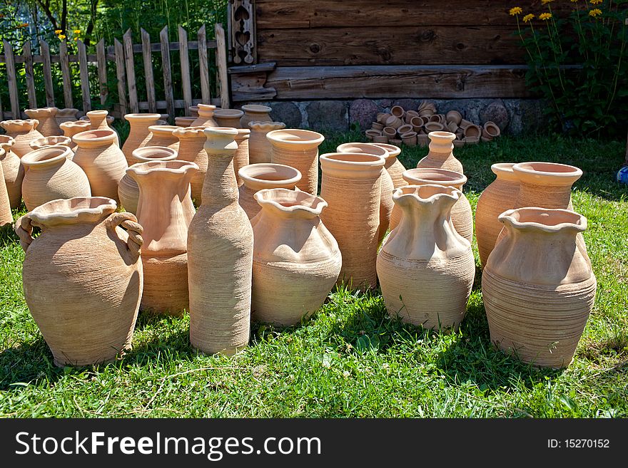 Old fashioned clay pots on grass