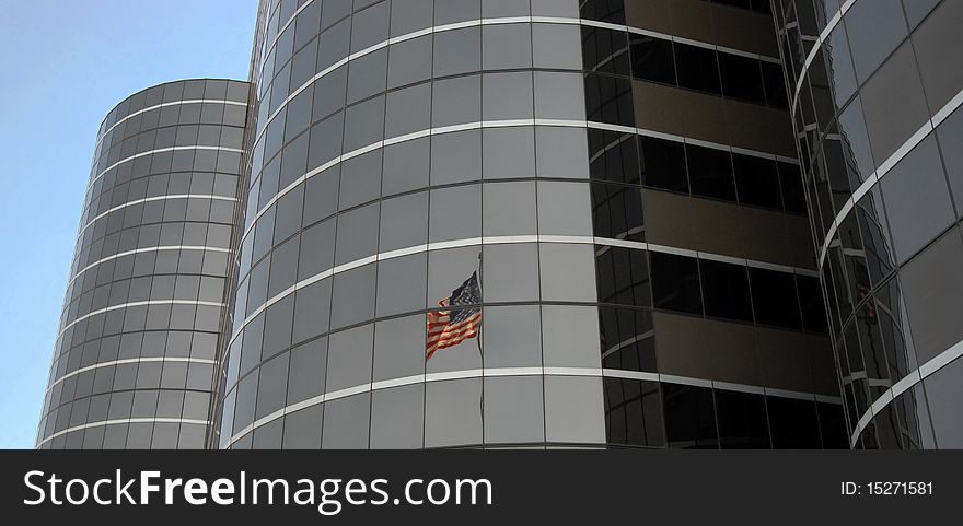 High rise building in Dallas, Texas with reflection of the American flag. High rise building in Dallas, Texas with reflection of the American flag.