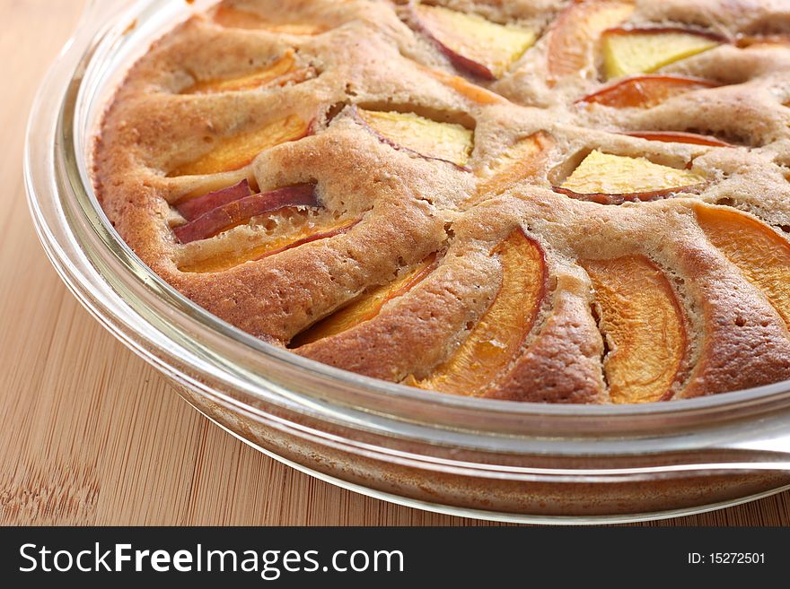 Apricot and peach pie on a transparent plate