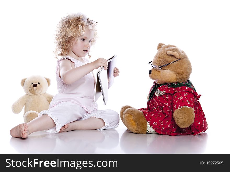 Cute baby girl with her teddy bear on white background