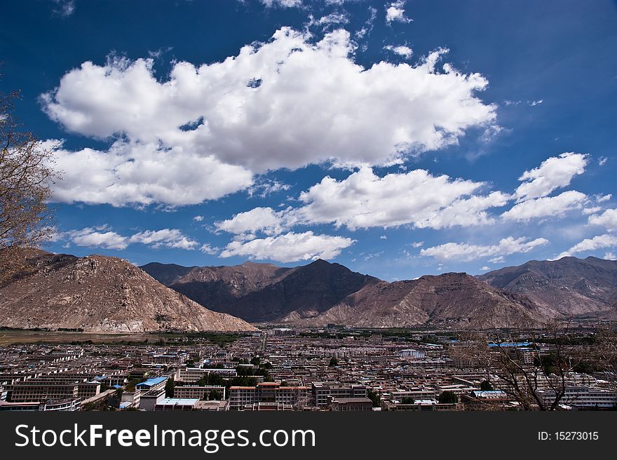 Lhasa city overview with great white cloudscape against blue sky