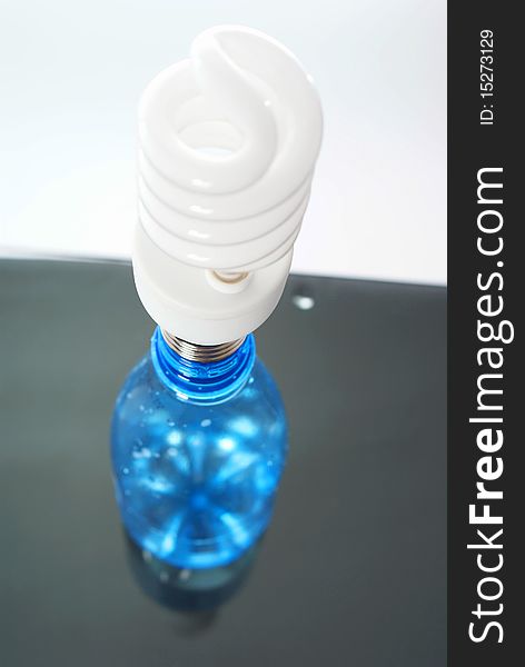 Energy saving bulb in plastic bottle isolated on white background