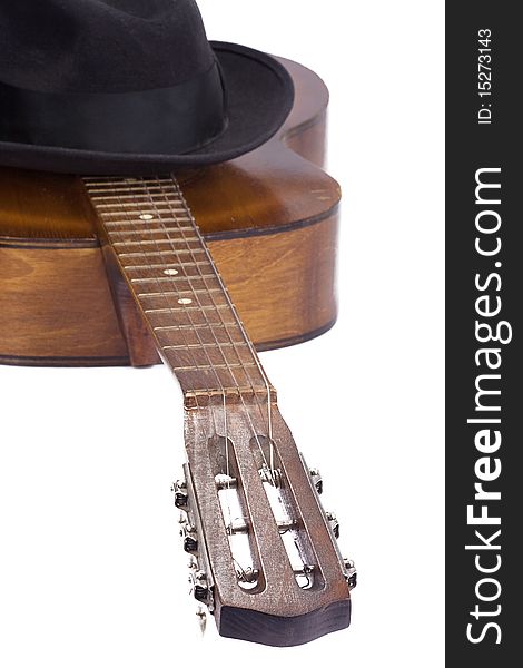 Classical guitar and hat on white