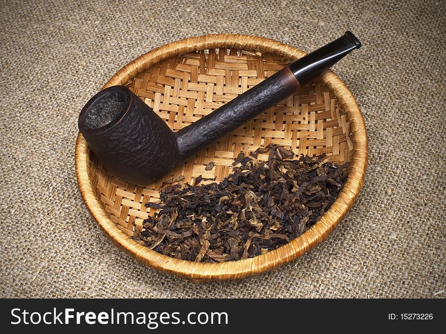 Tobacco pipe on the background fabric