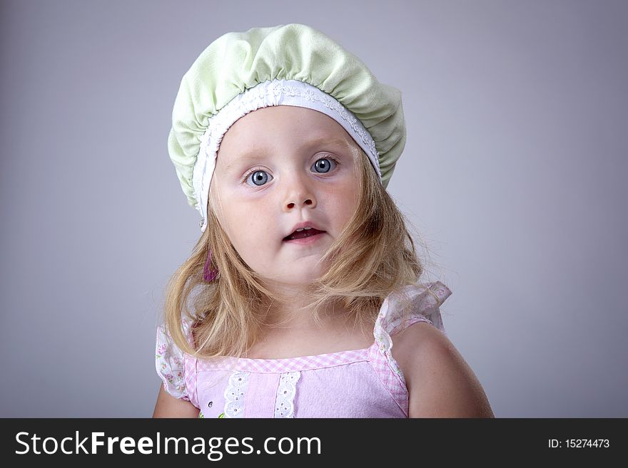 Very cute girl portrait with a funny green hat. Very cute girl portrait with a funny green hat