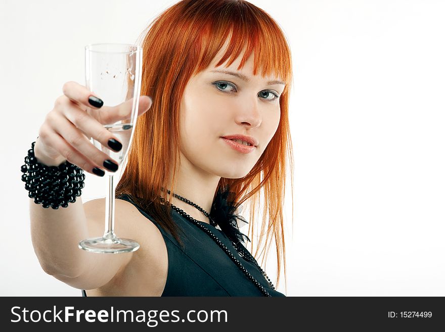 Beautiful red-haired girl lifts a toast, a glass with champagne