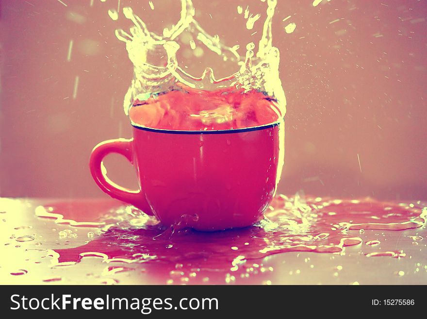 Water splashing from a pink cup. Water splashing from a pink cup