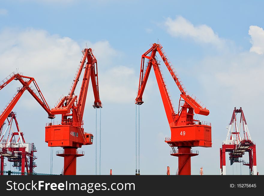 Mang cranes against blue sky，which taken in Qingdao Port China. Mang cranes against blue sky，which taken in Qingdao Port China