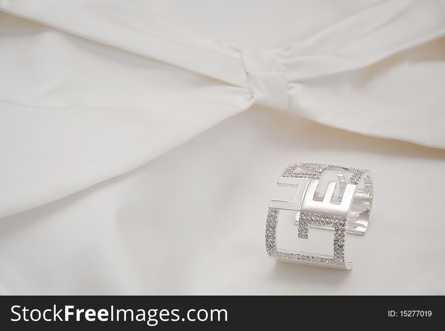 A bracelet on a white ceremony dress