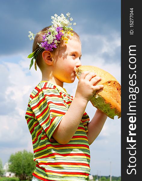 Boy Biting A Loaf Of Bread