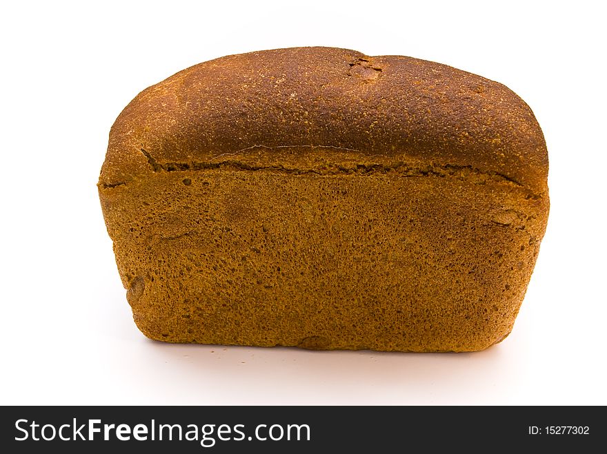 A loaf of fresh rye bread rectangular shape on a white background, top view. A loaf of fresh rye bread rectangular shape on a white background, top view