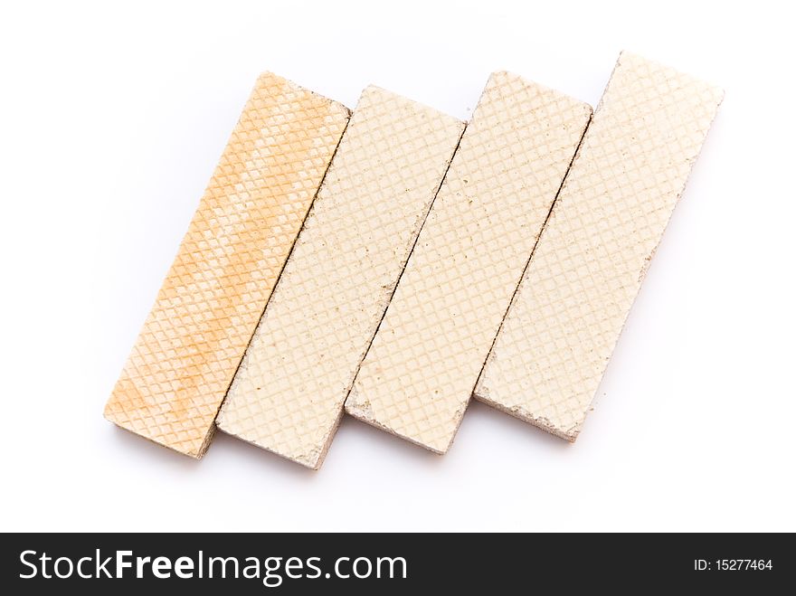 Sweet delicious waffles rectangular, four pieces, lying on a white background, top view. Sweet delicious waffles rectangular, four pieces, lying on a white background, top view