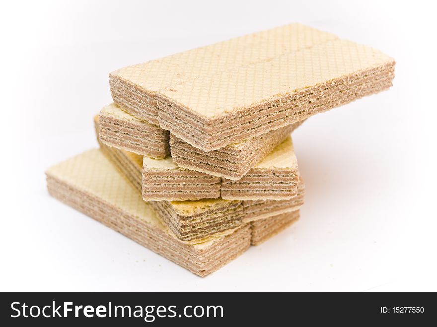 Sweet delicious crispy waffles rectangular shape, underlying spiral, on a white background. Sweet delicious crispy waffles rectangular shape, underlying spiral, on a white background