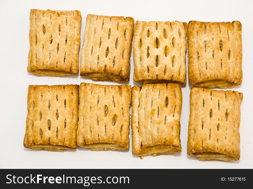 Sweet fresh pies with filling, lying on a white background. Sweet fresh pies with filling, lying on a white background