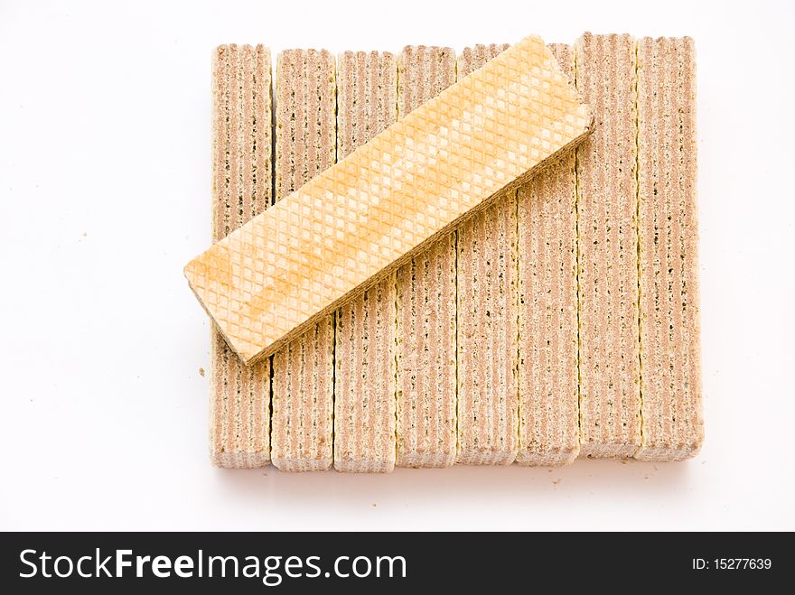 Sweet delicious waffles rectangular shape, one lies on a pile lying on the edge, top view, on a white background. Sweet delicious waffles rectangular shape, one lies on a pile lying on the edge, top view, on a white background
