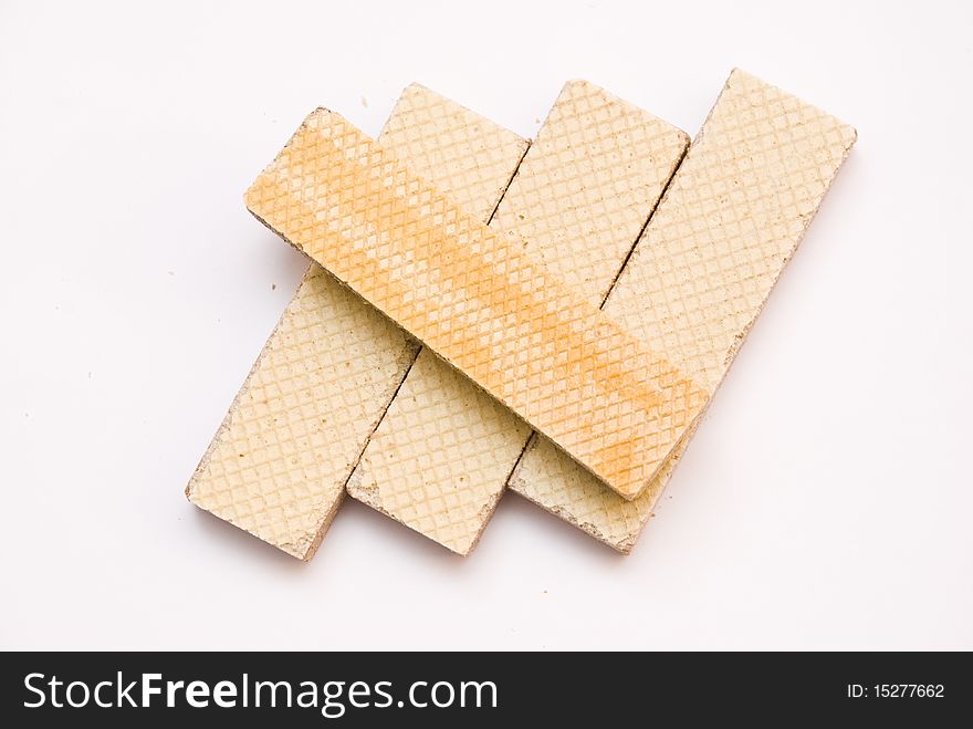 Sweet delicious waffles rectangular, four pieces, lying on a white background, top view