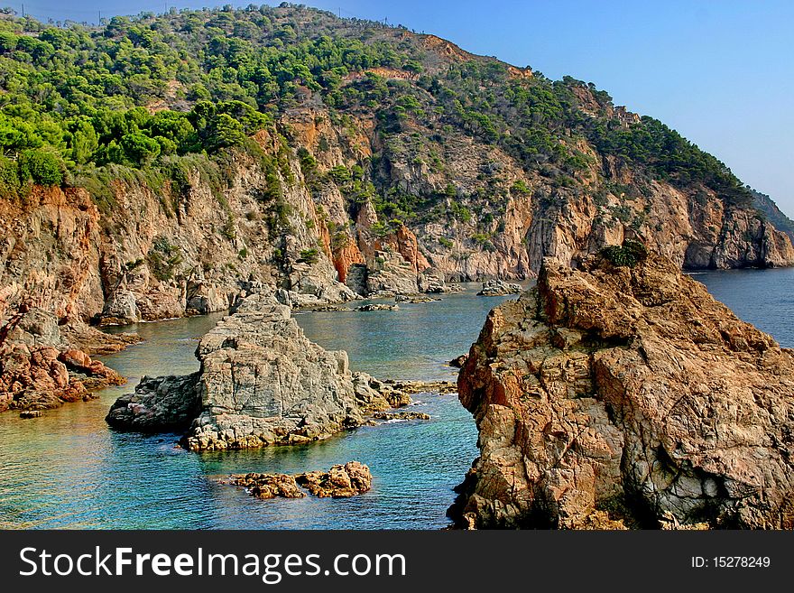 A rocky shore of the Mediterranean Sea and forbidding bay. A rocky shore of the Mediterranean Sea and forbidding bay.