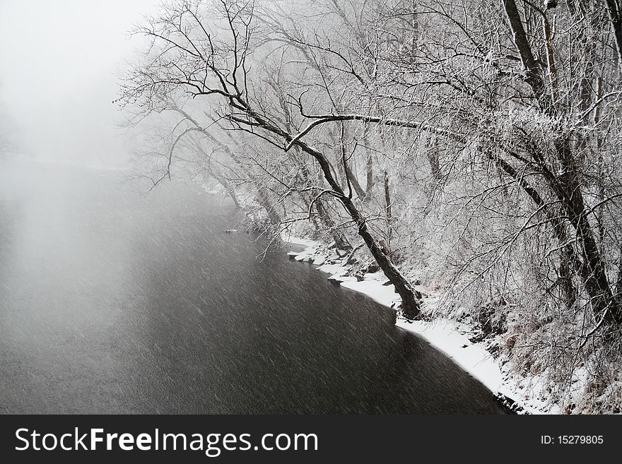 High contrast image of a river flowing through a snow storm. High contrast image of a river flowing through a snow storm.