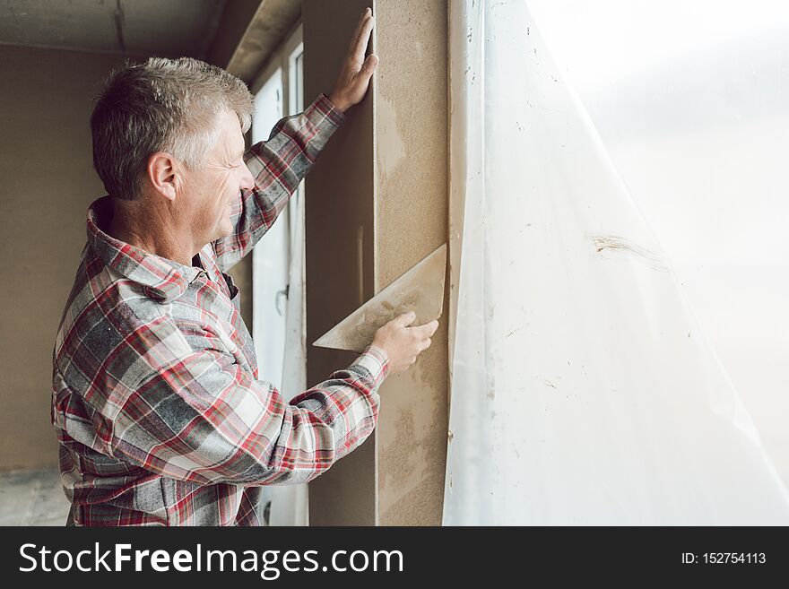 Diligent Plasterer Working On A Window Opening