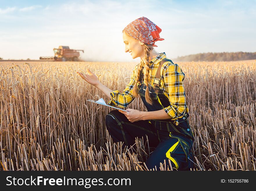 Farmer On A Field During Harvest With Clipboard