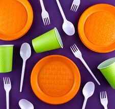 Plastic Orange Green Waste Collection On Purple Background. Concept Of Plastic Pollution And Ecology Problem Stock Image