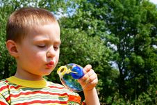 A Child Blowing Bubble Stock Image