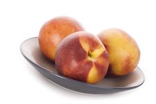 Three Peaches Lie On A Plate Royalty Free Stock Photo