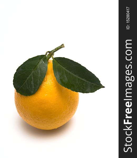 Lemon with green leaves isolated on white