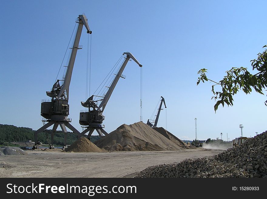 River port cranes, Oka river, Nizniy Novgorod, Russia. Industrial transportation of sand, gravel, etc.