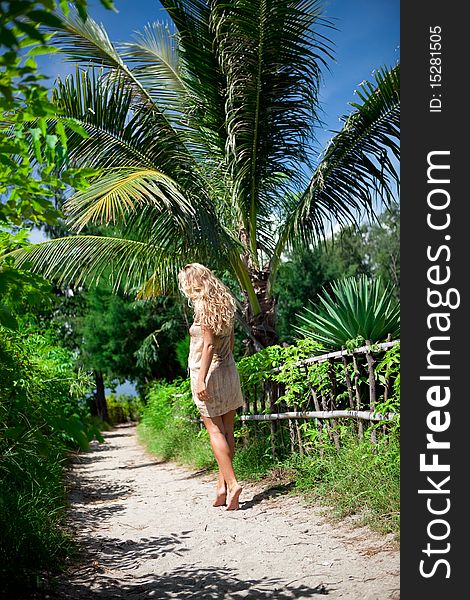 Girl walking on the road to jungle