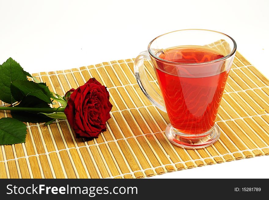 Cup of tea with red rose