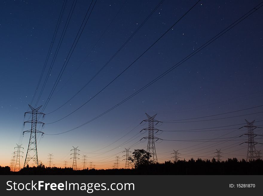 Powe pylons and lines on evening - against red sky and stars. Powe pylons and lines on evening - against red sky and stars