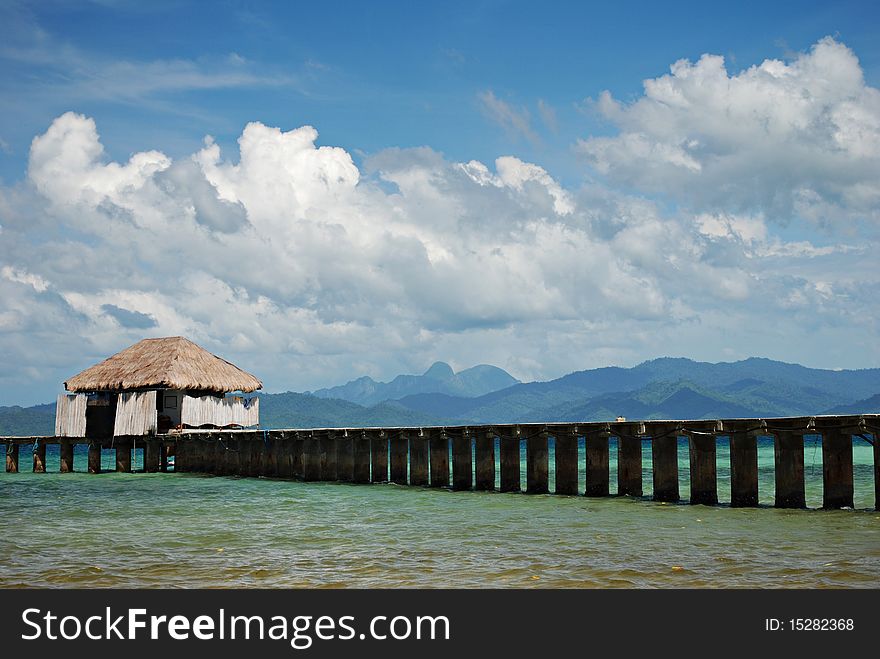 Tropical Beach Dock on a Blue Sky