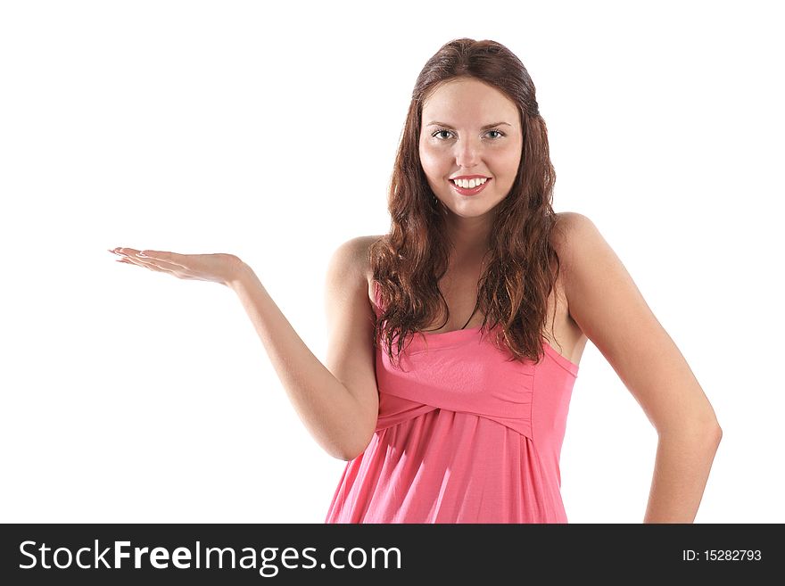 Smiling girl in pink dress presenting things isolated on white background