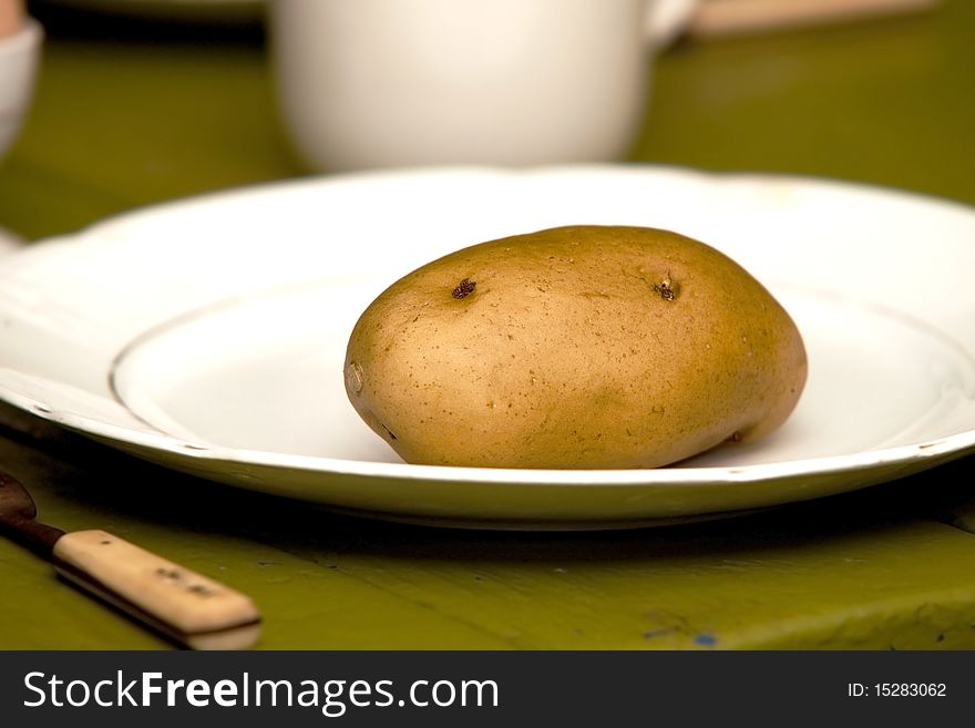 Potato on a large white dinner plate. Potato on a large white dinner plate