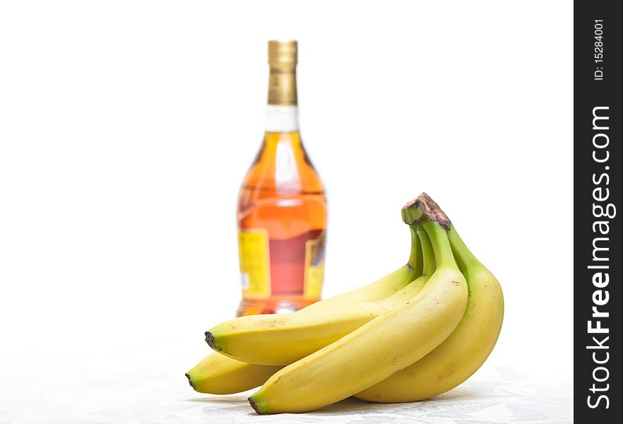 Bottle of  brandy and yellow banana isolated. Bottle of  brandy and yellow banana isolated