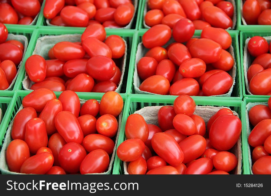 Baskets of Grape (cherry) Tomatoes at market. Baskets of Grape (cherry) Tomatoes at market