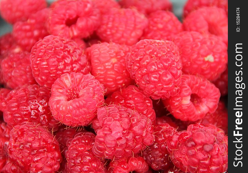 Full frame filled with red ripe raspberries