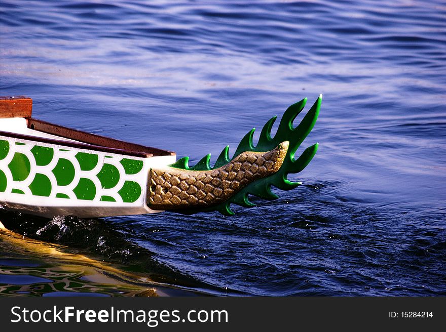 The dragon boat slips quietly through the water. The dragon boat slips quietly through the water